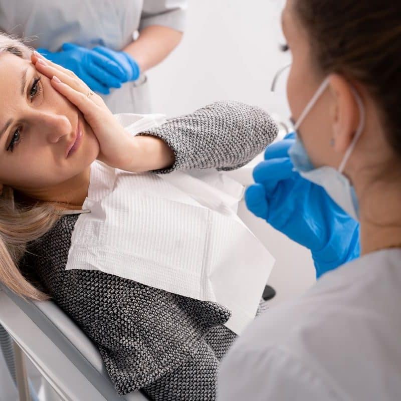 Woman Getting Treatment For A Dental Emergency