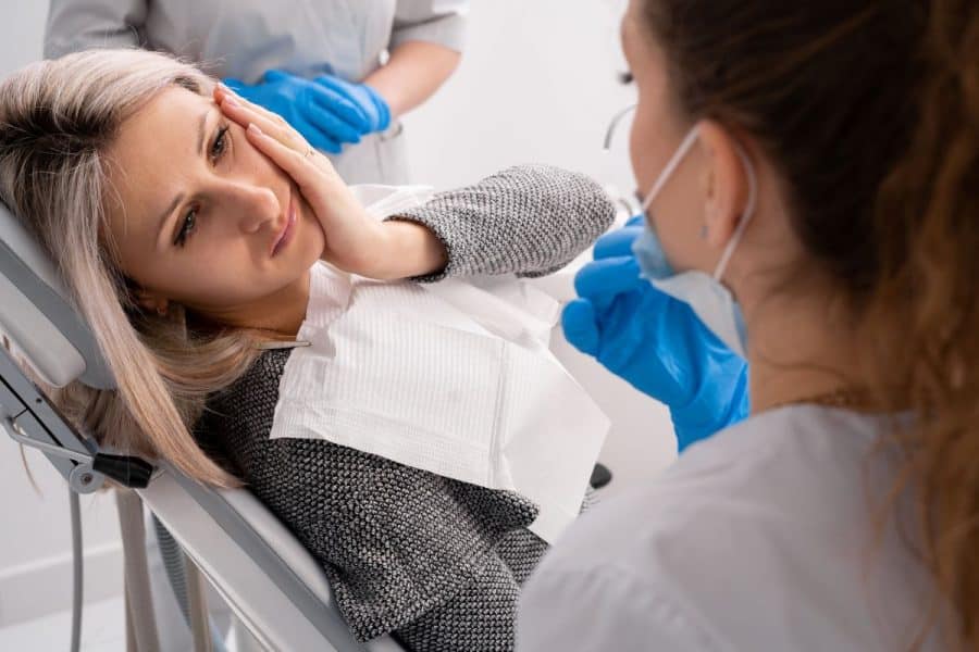 Woman Getting Treatment For A Dental Emergency